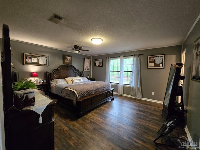 4940 Dawson Rd, Century, FL 32535 - bedroom featuring crown molding, dark wood-type flooring, a textured ceiling, visible vents, and baseboards