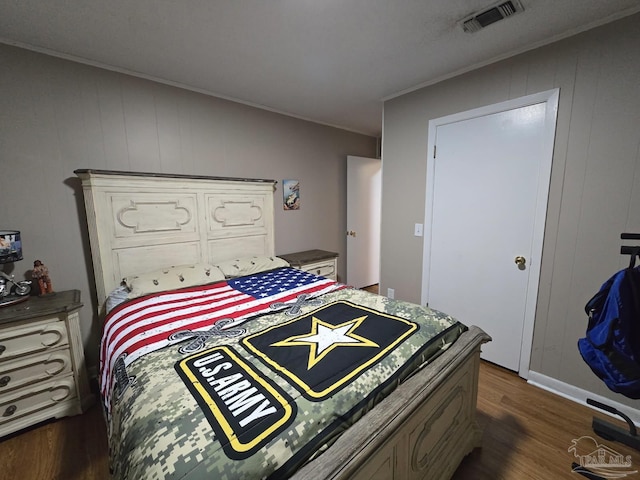 4940 Dawson Rd, Century, FL 32535 - bedroom with ornamental molding, dark wood-style floors, and visible vents