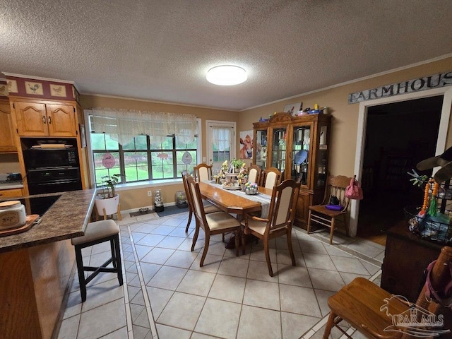 4940 Dawson Rd, Century, FL 32535 - dining room featuring a textured ceiling, light tile patterned floors, baseboards, and ornamental molding