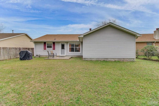 rear view of property with a patio area, a fenced backyard, and a yard