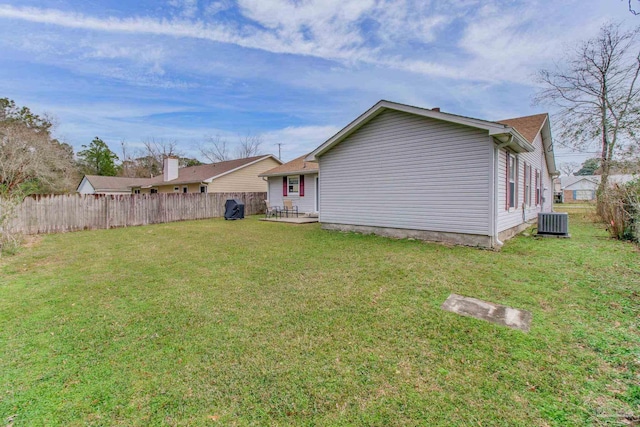 view of yard featuring fence, cooling unit, and a patio