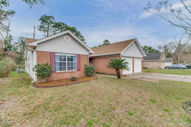 ranch-style home with a front yard, brick siding, and driveway