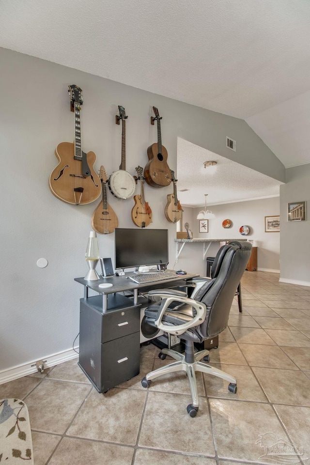 office space with lofted ceiling, light tile patterned flooring, visible vents, and baseboards