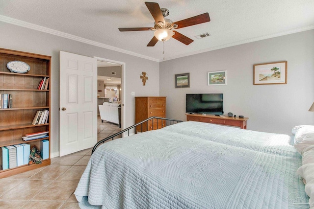 bedroom featuring tile patterned flooring, visible vents, crown molding, and a textured ceiling