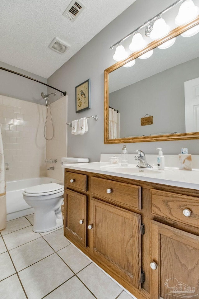 full bath featuring a textured ceiling, tile patterned flooring, toilet, visible vents, and vanity