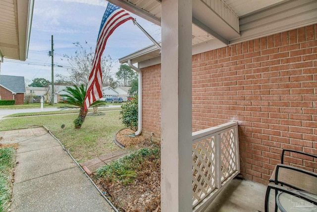 view of property exterior featuring a yard and brick siding