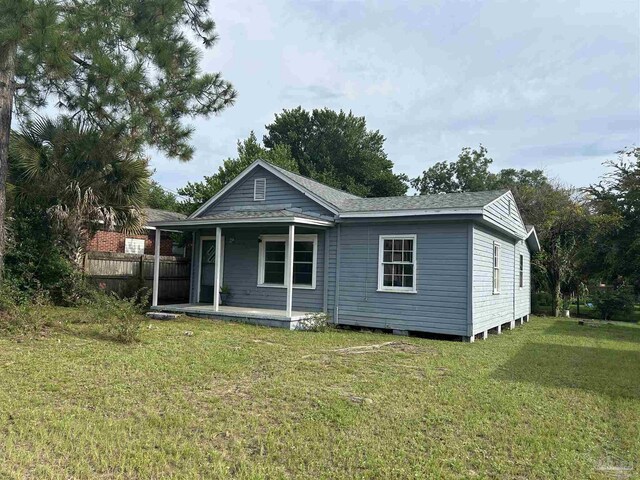 back of property with a lawn