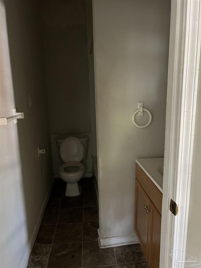 bathroom with tile patterned flooring, vanity, and toilet