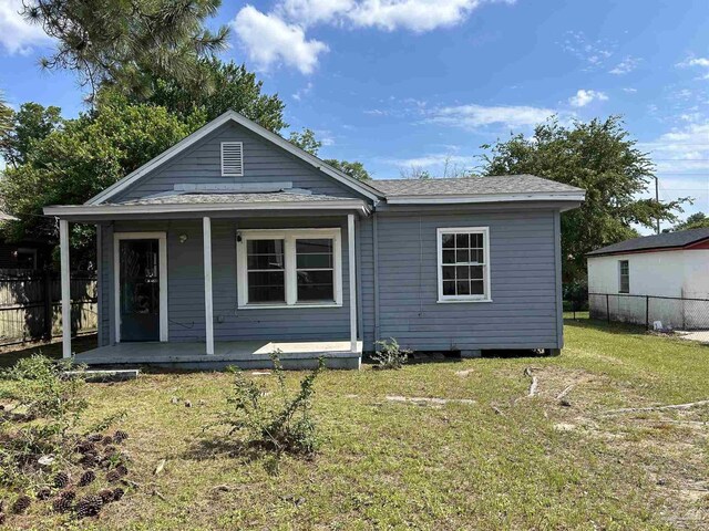 back of house with a yard