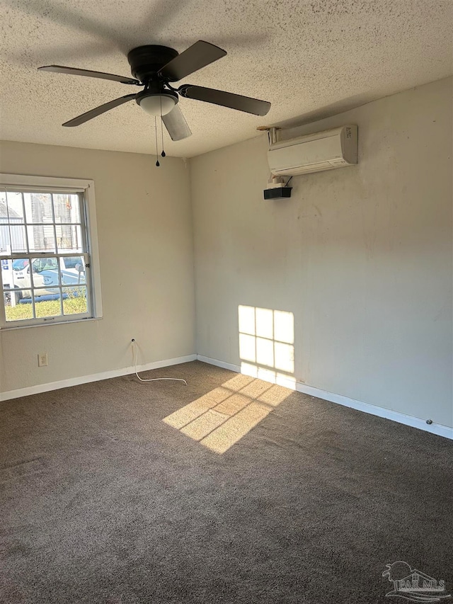 spare room with ceiling fan, carpet flooring, a textured ceiling, and a wall unit AC