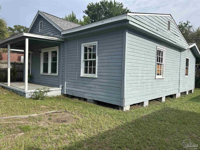 view of property exterior with a yard