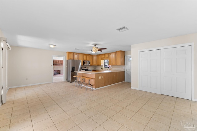 3332 Laurel Dr, Gulf Breeze, FL 32563 - kitchen featuring appliances with stainless steel finishes, a ceiling fan, light countertops, a peninsula, and a sink