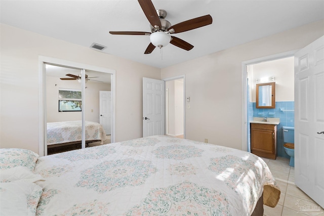 3332 Laurel Dr, Gulf Breeze, FL 32563 - bedroom with light tile patterned flooring, a closet, a ceiling fan, and ensuite bath