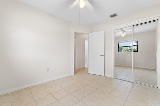 3332 Laurel Dr, Gulf Breeze, FL 32563 - unfurnished bedroom with light tile patterned floors, a closet, a ceiling fan, and baseboards