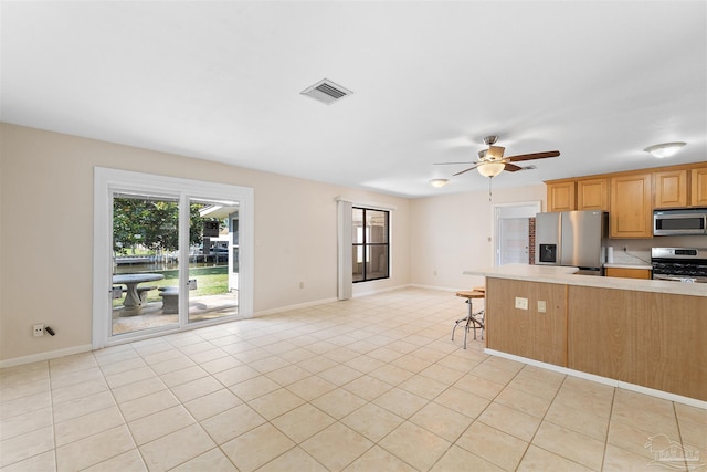3332 Laurel Dr, Gulf Breeze, FL 32563 - kitchen featuring stainless steel appliances, light countertops, baseboards, ceiling fan, and light tile patterned flooring