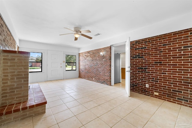 3332 Laurel Dr, Gulf Breeze, FL 32563 - unfurnished room featuring brick wall, a ceiling fan, and light tile patterned floors