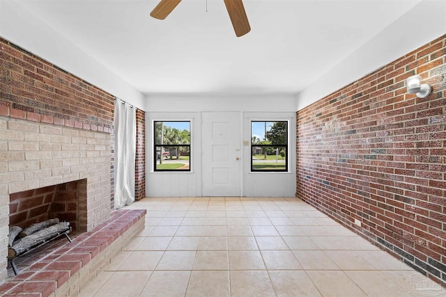 3332 Laurel Dr, Gulf Breeze, FL 32563 - unfurnished living room with a ceiling fan, brick wall, light tile patterned floors, and a fireplace