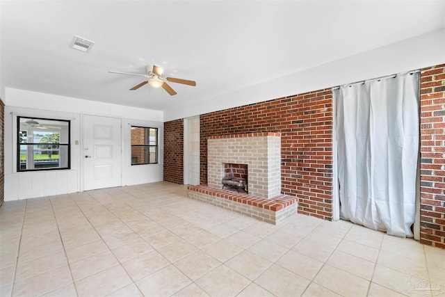 3332 Laurel Dr, Gulf Breeze, FL 32563 - unfurnished living room featuring ceiling fan, brick wall, a fireplace, and light tile patterned floors