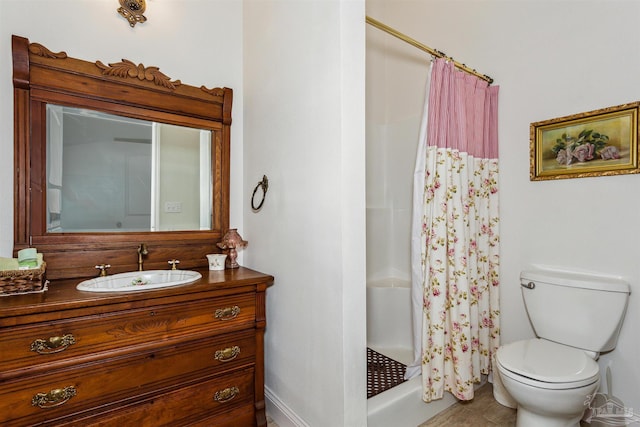 bathroom featuring vanity, curtained shower, and toilet