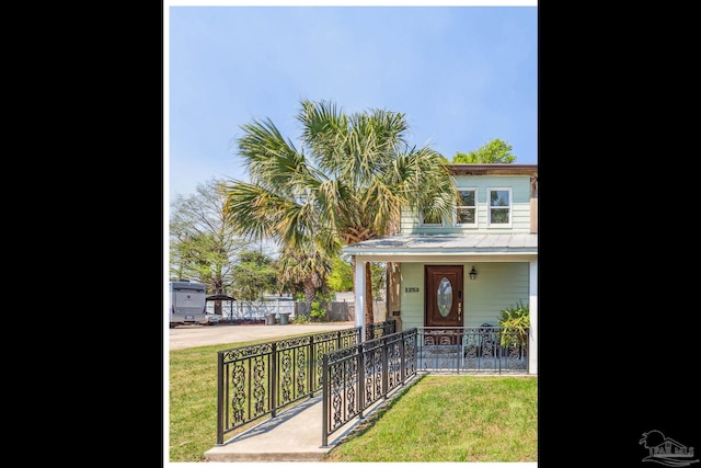 view of front of home featuring a front lawn and a porch