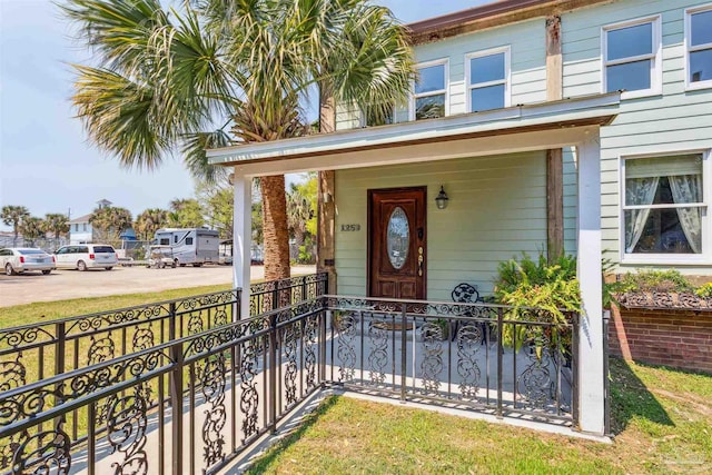 doorway to property featuring covered porch