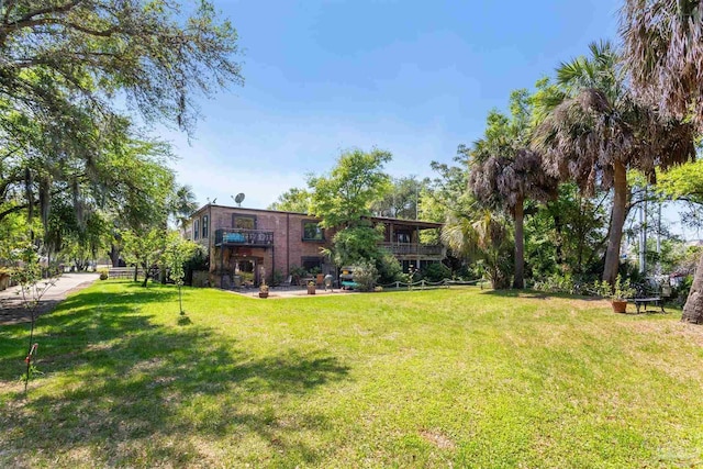 view of yard featuring a balcony and a patio area