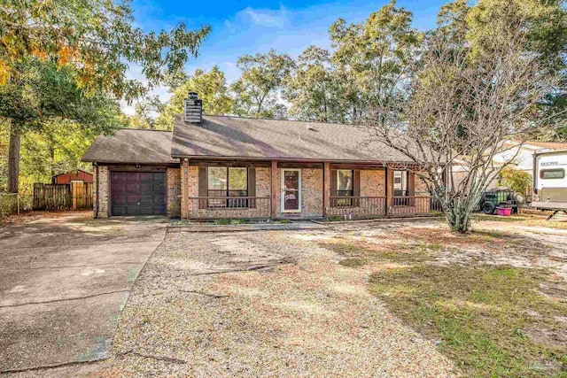 ranch-style house with a porch and a garage