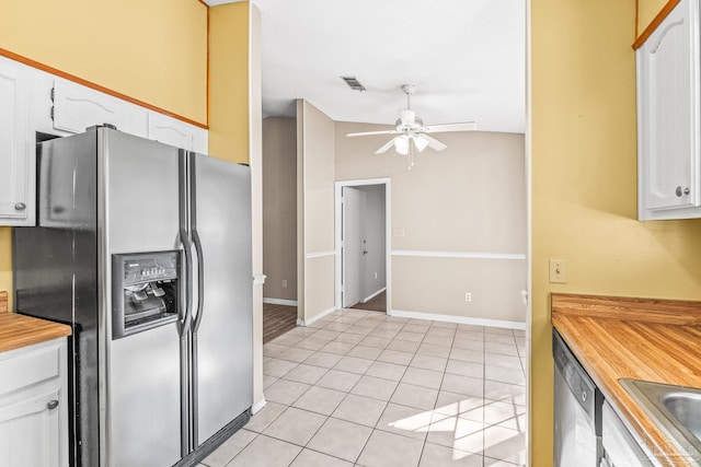 kitchen with appliances with stainless steel finishes, light tile patterned floors, white cabinetry, and ceiling fan