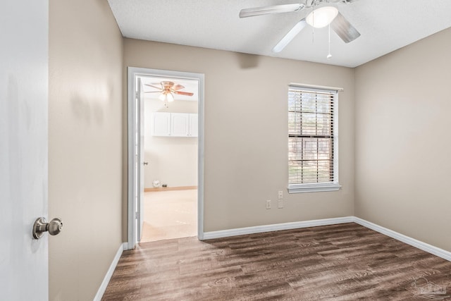 empty room with wood-type flooring, a textured ceiling, and ceiling fan