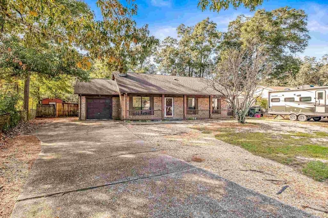 ranch-style house with covered porch and a garage