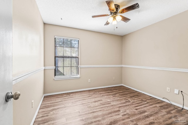 unfurnished room with hardwood / wood-style floors, a textured ceiling, and ceiling fan