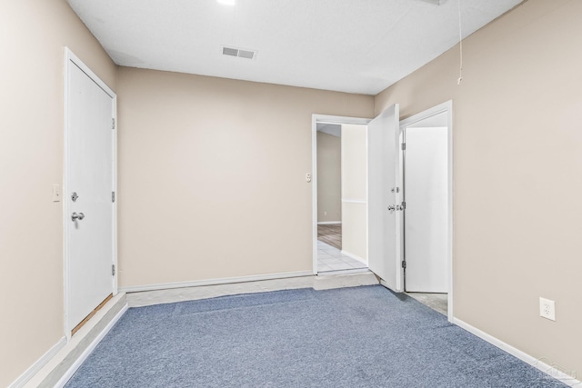 spare room featuring light colored carpet