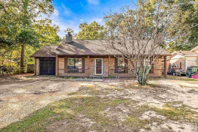 ranch-style house featuring a porch and a garage