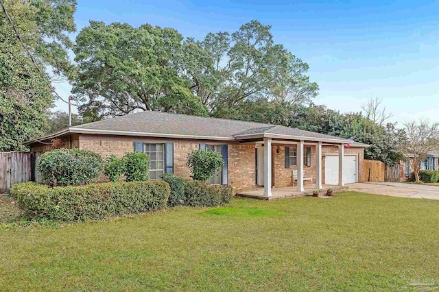 ranch-style home featuring a garage and a front lawn