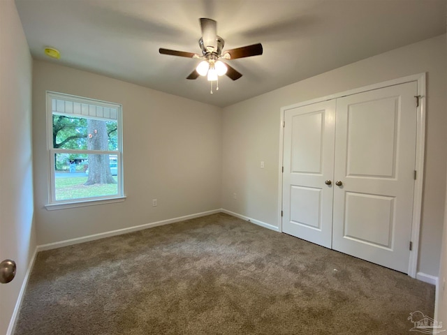 unfurnished bedroom featuring carpet floors, ceiling fan, and a closet