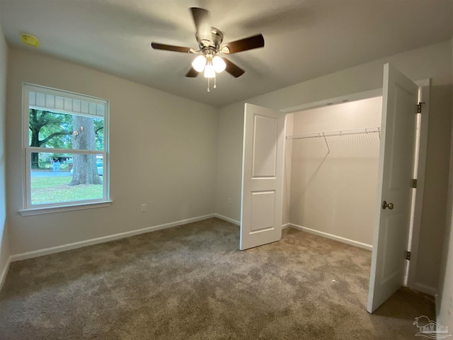 unfurnished bedroom with light carpet, ceiling fan, and a closet