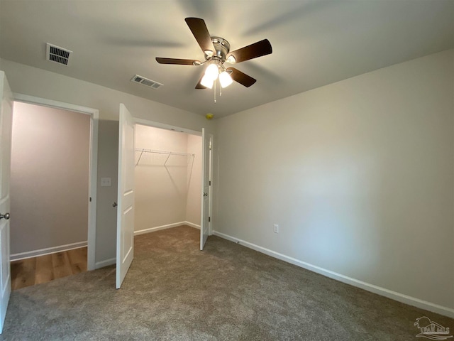 unfurnished bedroom with ceiling fan, a closet, and carpet