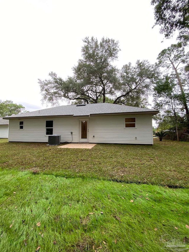 back of house with a yard and a patio area