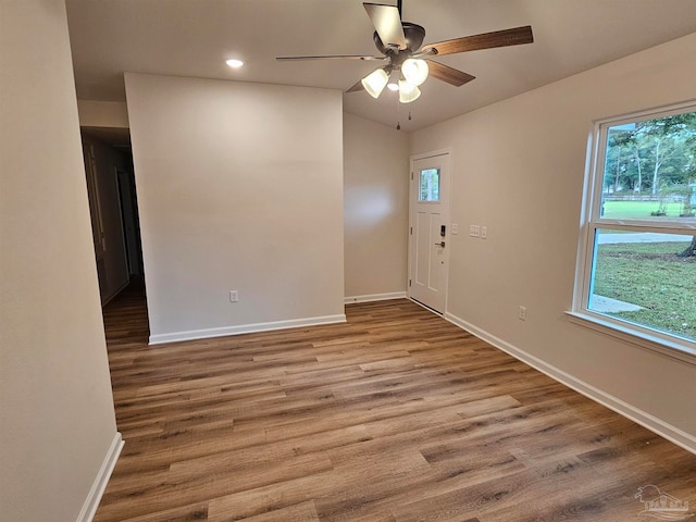 empty room with ceiling fan and light wood-type flooring