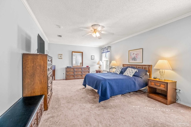 bedroom with ceiling fan, crown molding, carpet, and a textured ceiling