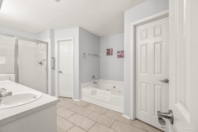 bathroom with vanity, shower with separate bathtub, a textured ceiling, and tile patterned floors