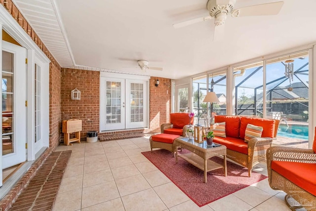 sunroom featuring ceiling fan and french doors