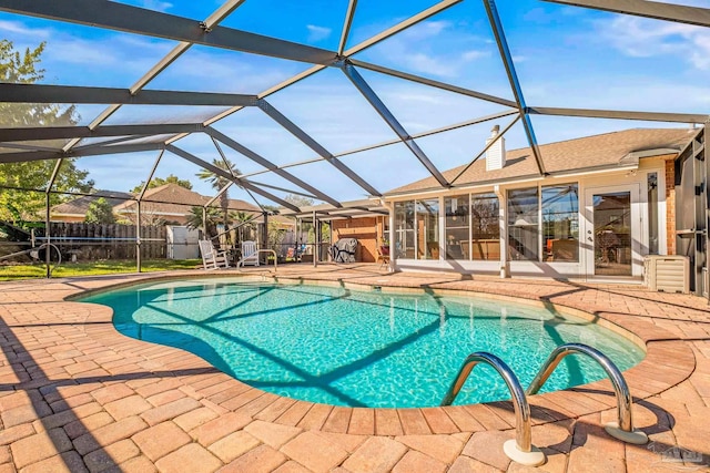 view of swimming pool with a lanai and a patio