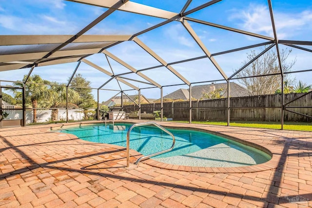 view of swimming pool with a patio and a lanai