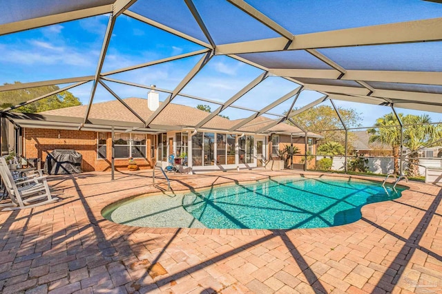 view of swimming pool with a patio and glass enclosure