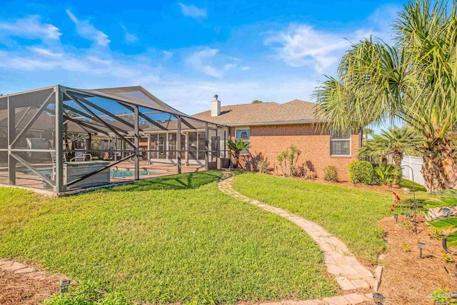 view of yard featuring glass enclosure, a patio area, and a pool