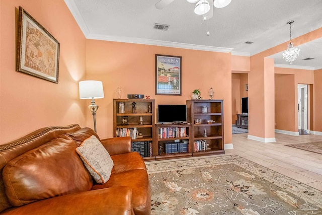 living room with crown molding, ceiling fan, and a textured ceiling