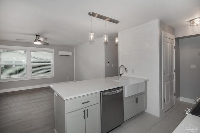 kitchen with ceiling fan, dishwasher, sink, an AC wall unit, and decorative light fixtures