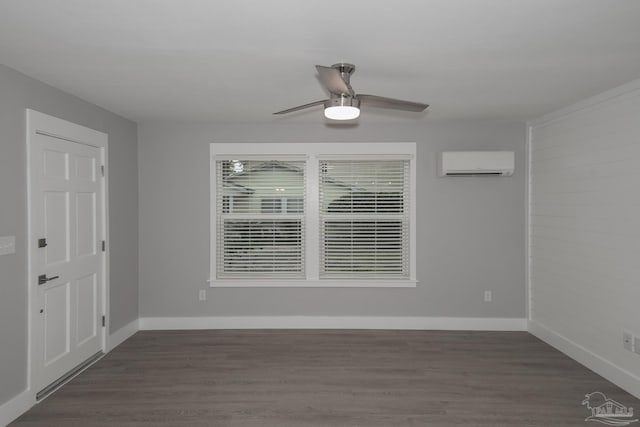 spare room featuring a wall unit AC, ceiling fan, and dark hardwood / wood-style flooring