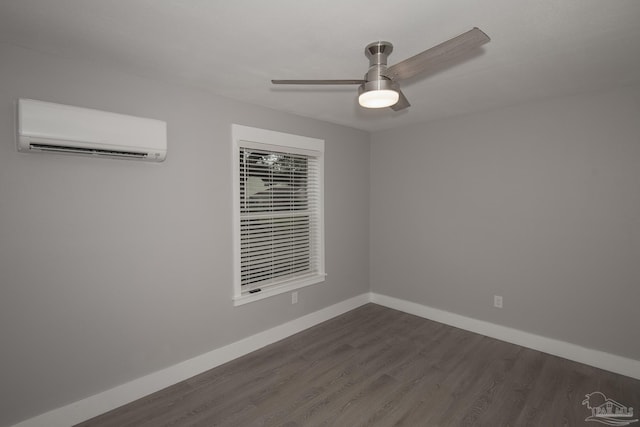 spare room with ceiling fan, dark hardwood / wood-style floors, and a wall mounted AC